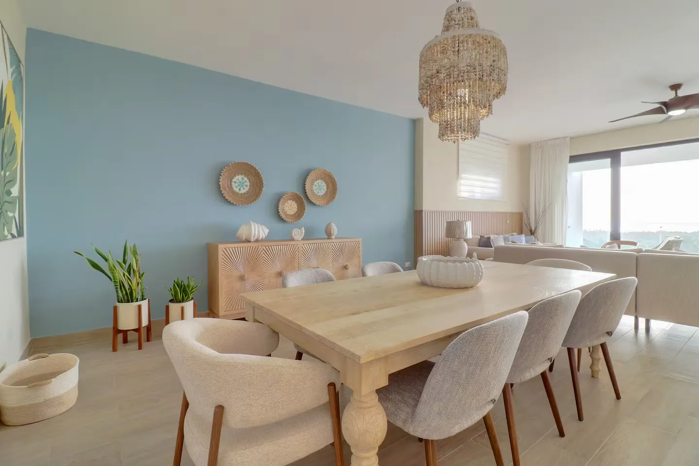 Eight-seat dining table beneath crystal chandelier