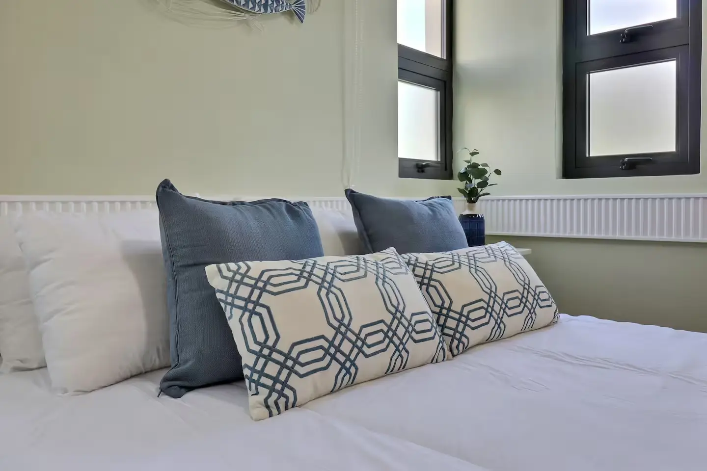 Guest bedroom with tailored pillows in coastal blue