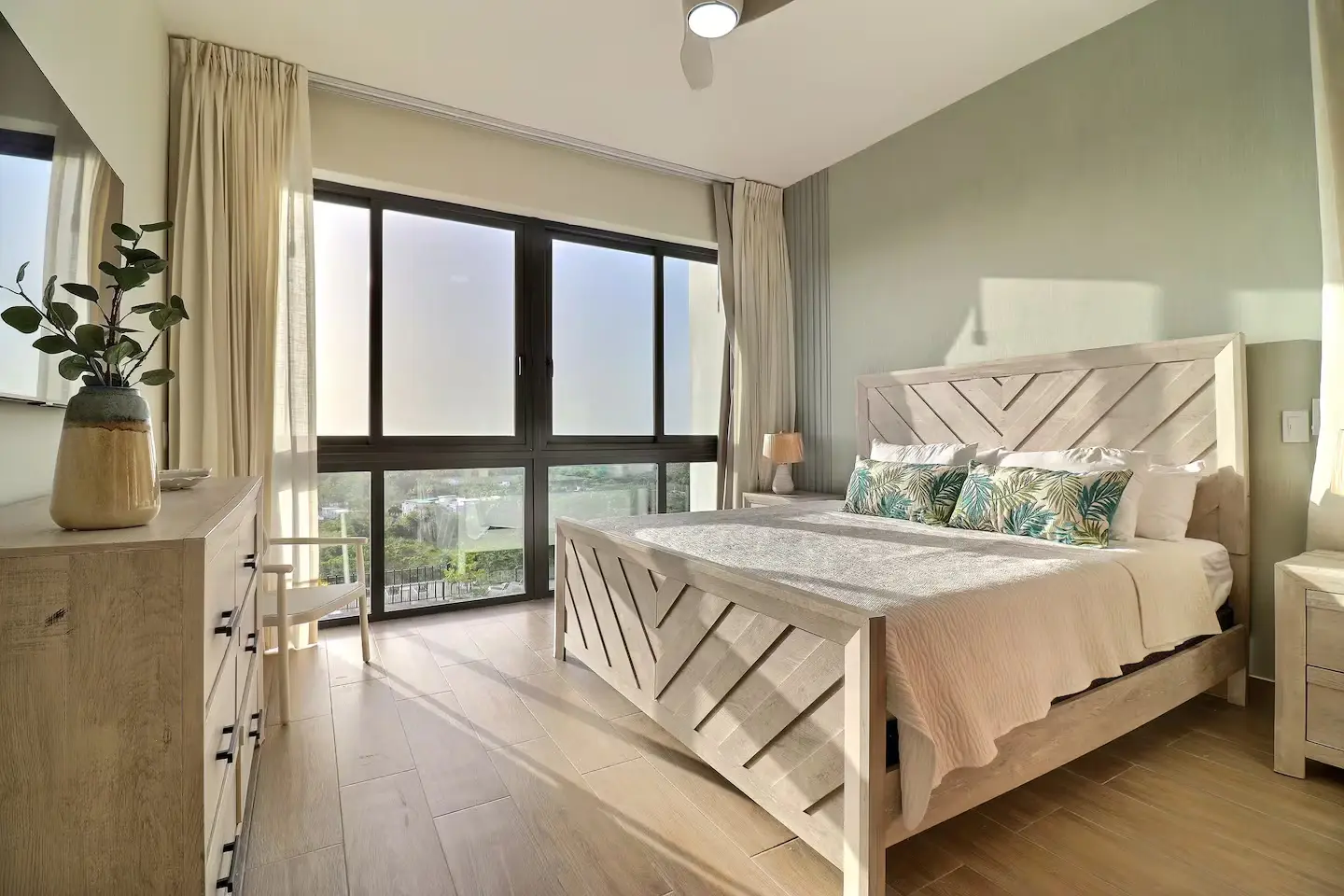 Master bed with floor-to-ceiling ocean view
