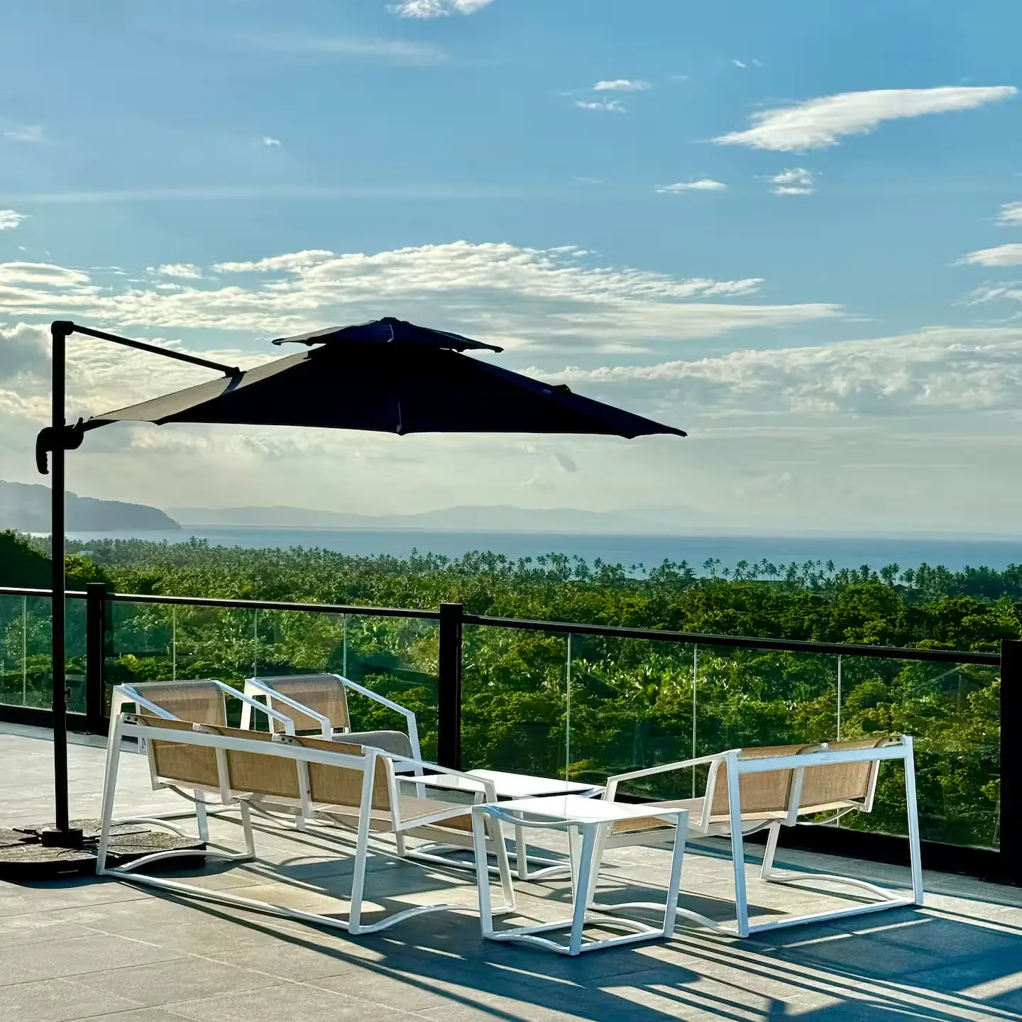 Terrace lounge with panoramic Caribbean view at golden hour
