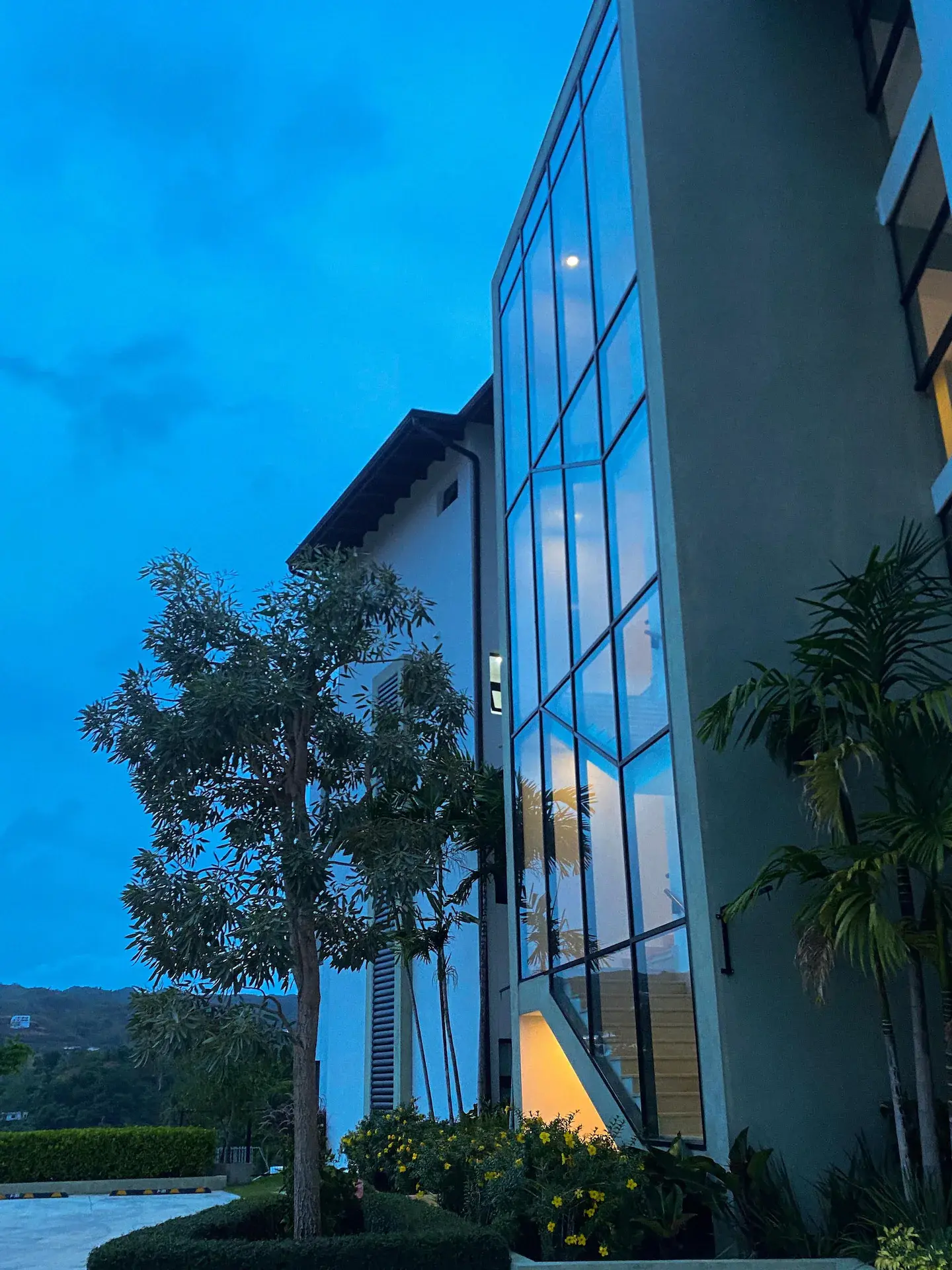 Building exterior at blue hour with warm interior light
