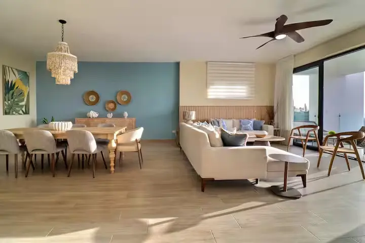 Open dining and living areas with hand-beaded chandelier
