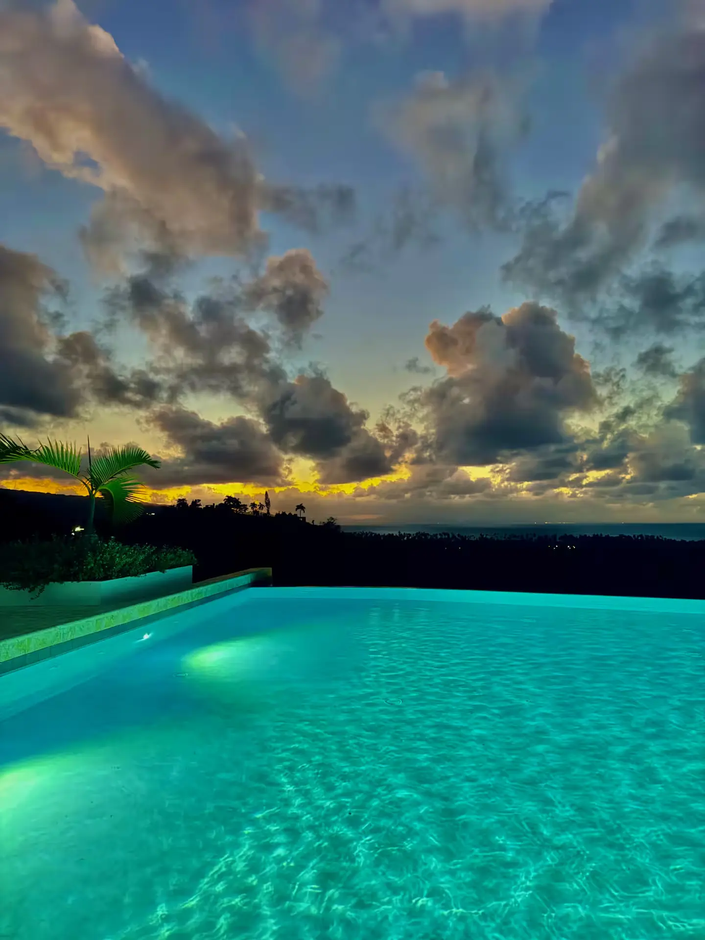 Heated infinity pool overlooking the Caribbean at dusk