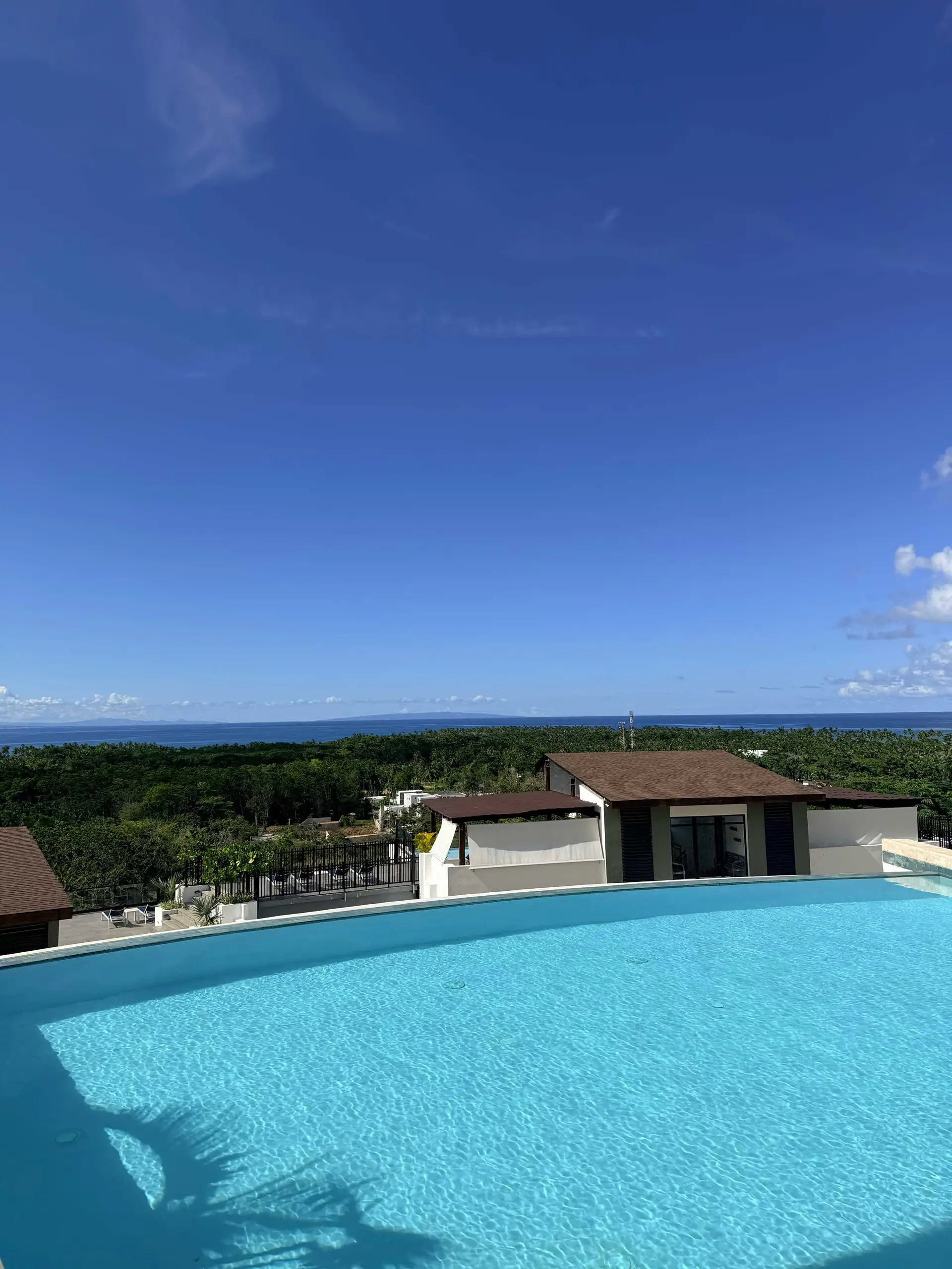 Pool deck with the residence and the Caribbean in the background